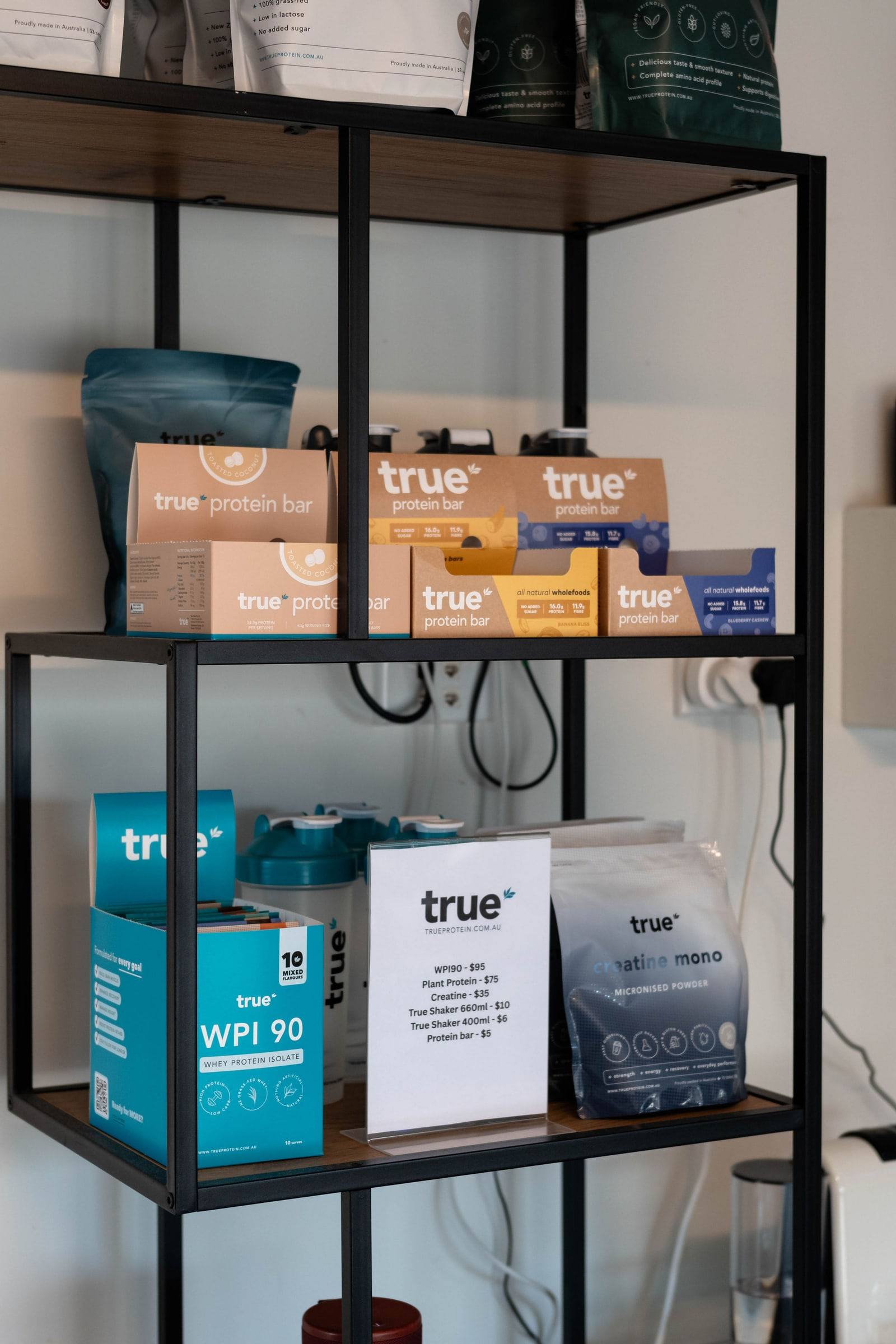 Shelves stocked with protein and supplements in the gym