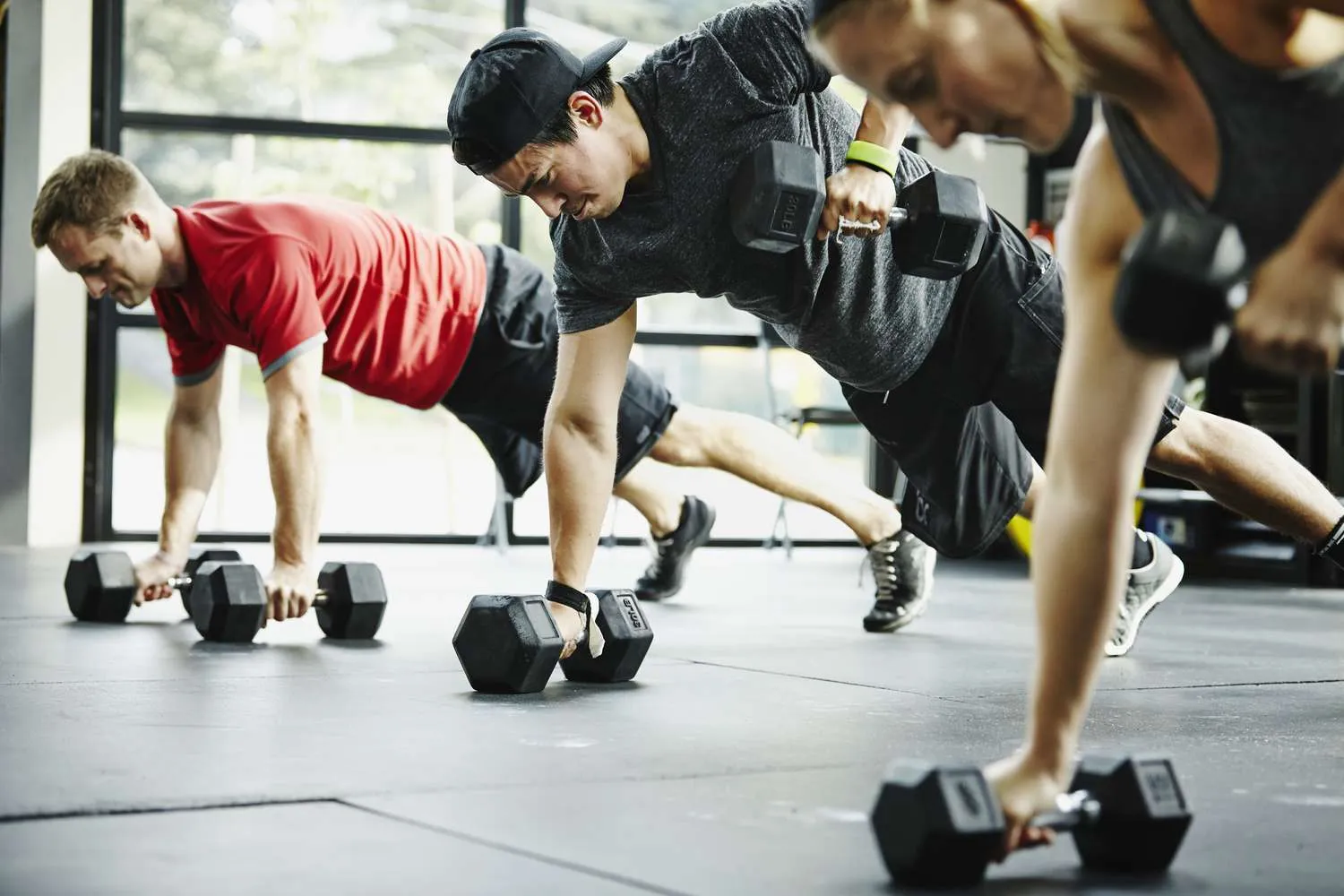 People engaging in resistance training with dumbbells, highlighting the benefits of building strength, improving endurance, and enhancing overall fitness levels.